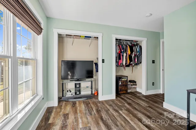 a view of a livingroom with furniture and a flat screen tv