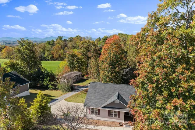 a view of house with yard and mountain view in back