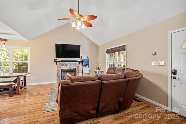 a living room with furniture a fireplace and a flat screen tv