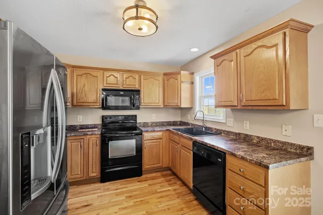 a kitchen with stainless steel appliances granite countertop a stove and a refrigerator