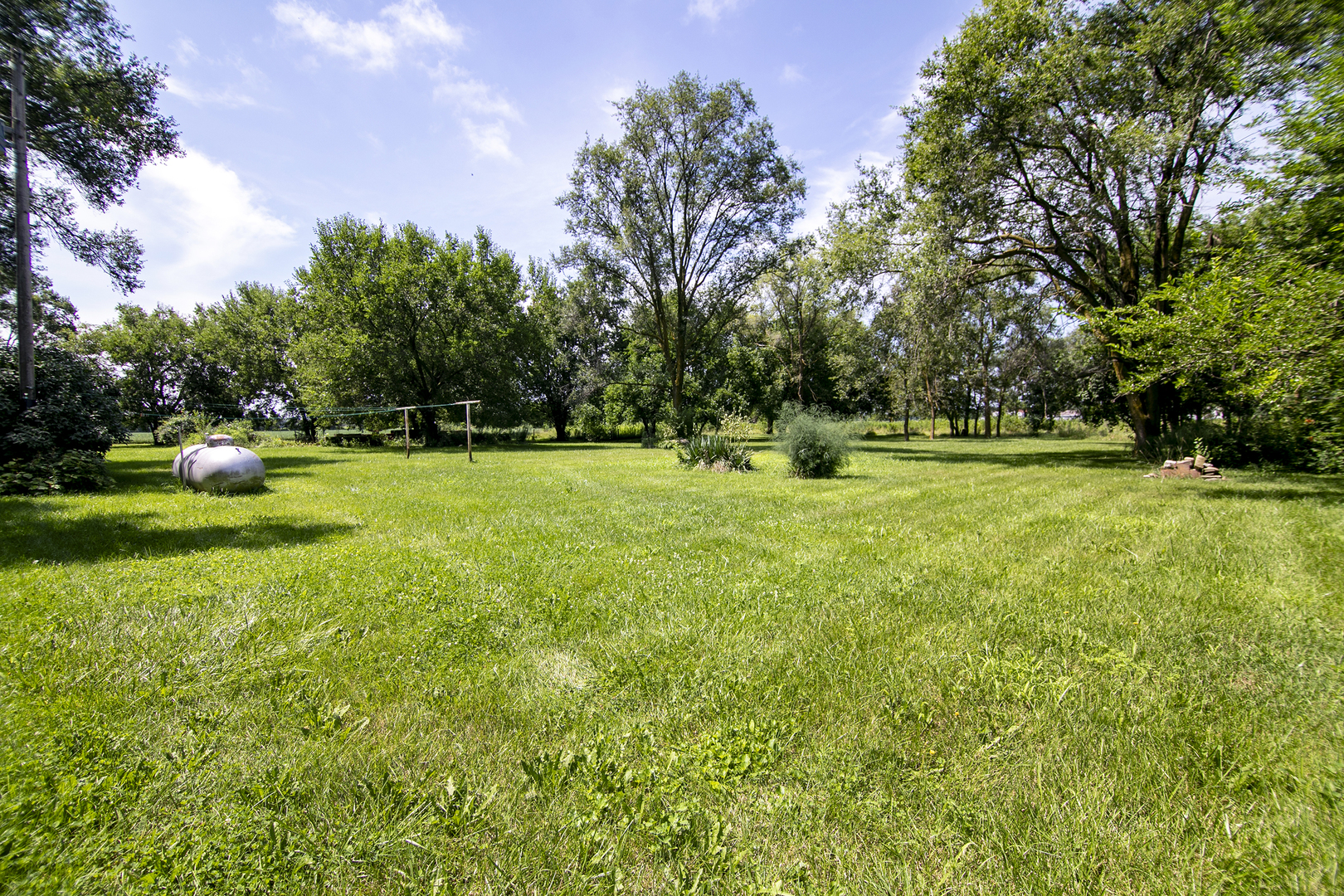1757 East 3000 North Road Martinton, IL 60951 - Photo 22 of 33 a view of a grassy field with trees around