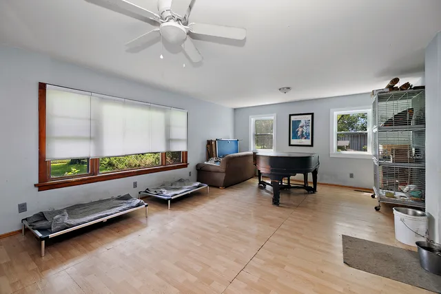 a living room with furniture gym equipment and a window