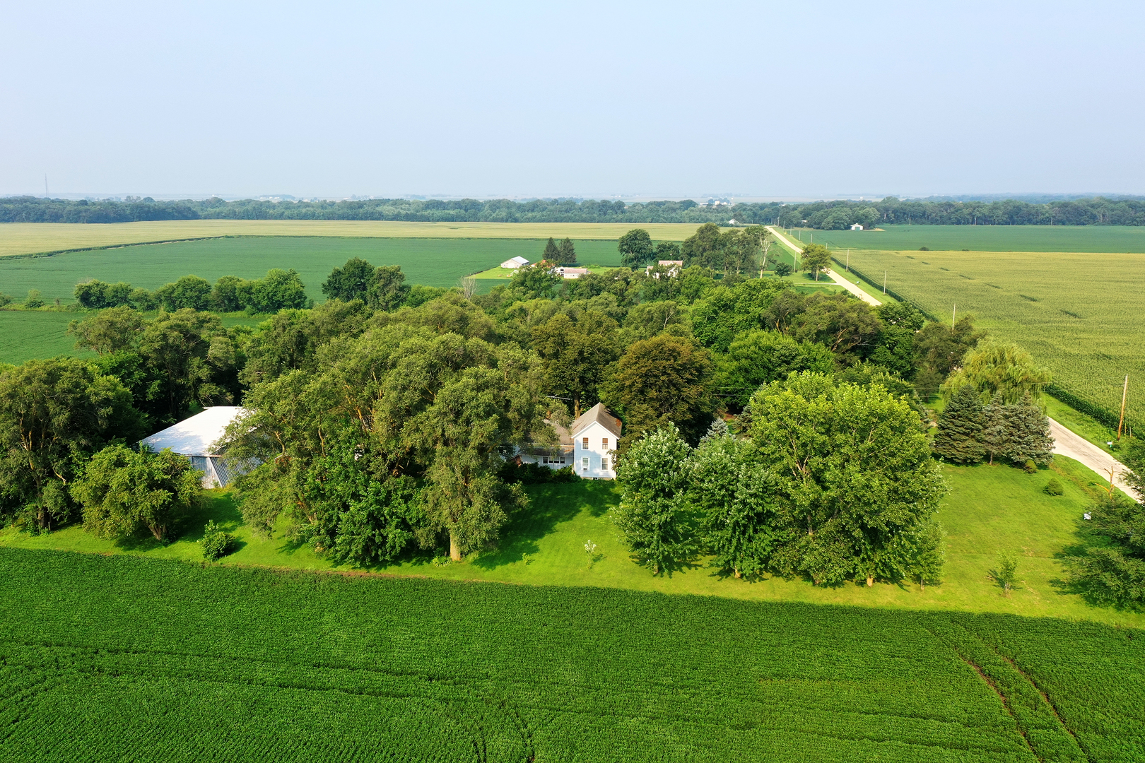 1757 East 3000 North Road Martinton, IL 60951 - Photo 32 of 33 a view of a lake with a building in the background