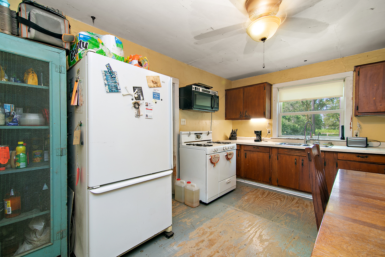1757 East 3000 North Road Martinton, IL 60951 - Photo 7 of 33 a white refrigerator freezer sitting in a kitchen