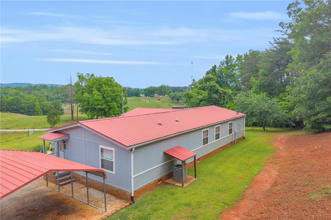 721 Cedar Crest Trail Walhalla, SC 29691 - Photo 45 of 47 Perched on a verdant hillside, this home provides pastoral views and a welcoming carport.