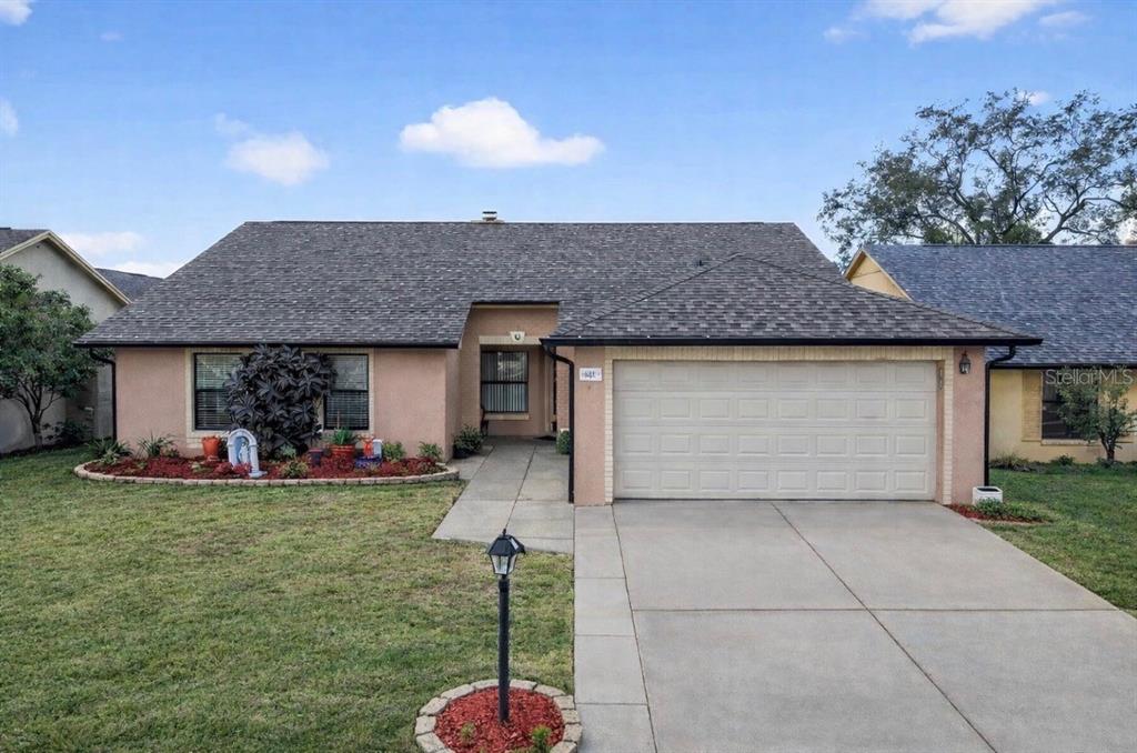 a view of a house with backyard and sitting area