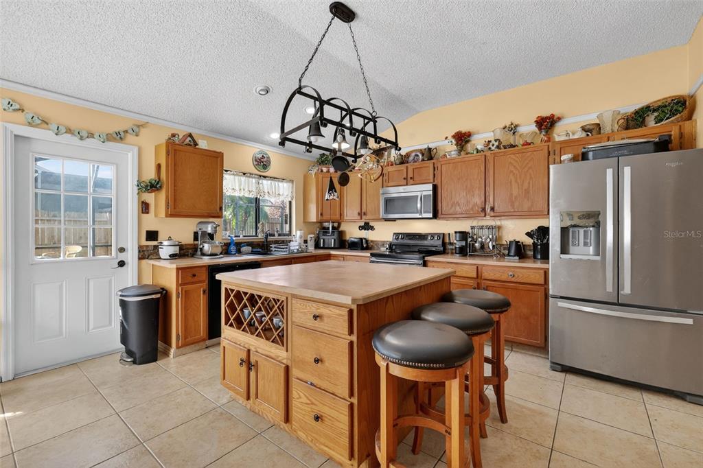562 Hassocks Loop Lake Mary, FL 32746 - Photo 11 of 34 a kitchen with stainless steel appliances granite countertop a stove and a refrigerator