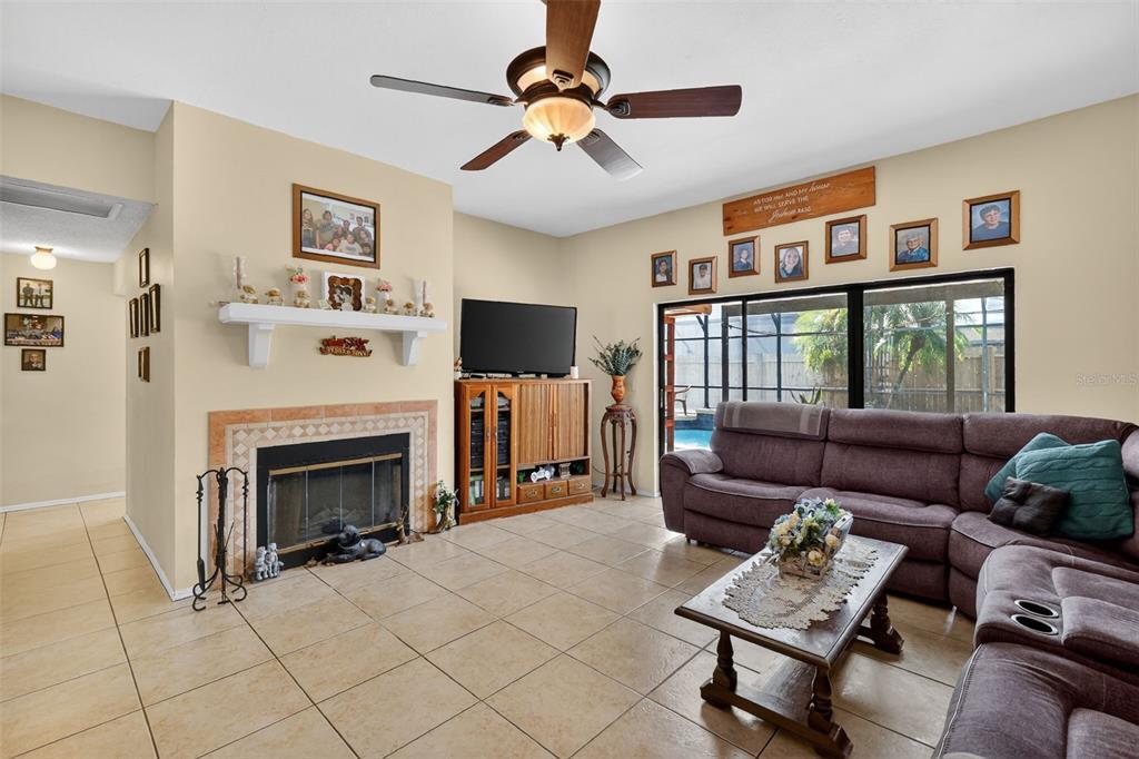 562 Hassocks Loop Lake Mary, FL 32746 - Photo 19 of 34 a living room with furniture a fireplace and a flat screen tv