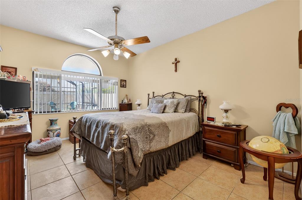 562 Hassocks Loop Lake Mary, FL 32746 - Photo 22 of 34 a bedroom with a bed and a chandelier