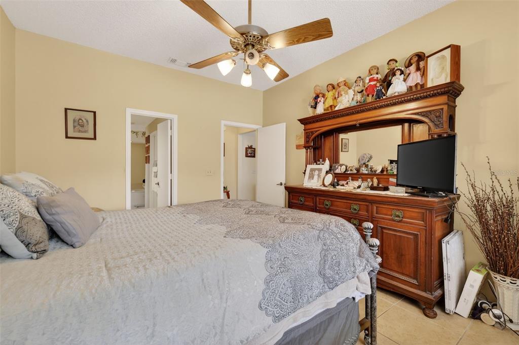 562 Hassocks Loop Lake Mary, FL 32746 - Photo 23 of 34 a bedroom with a bed and a flat tv screen on dresser