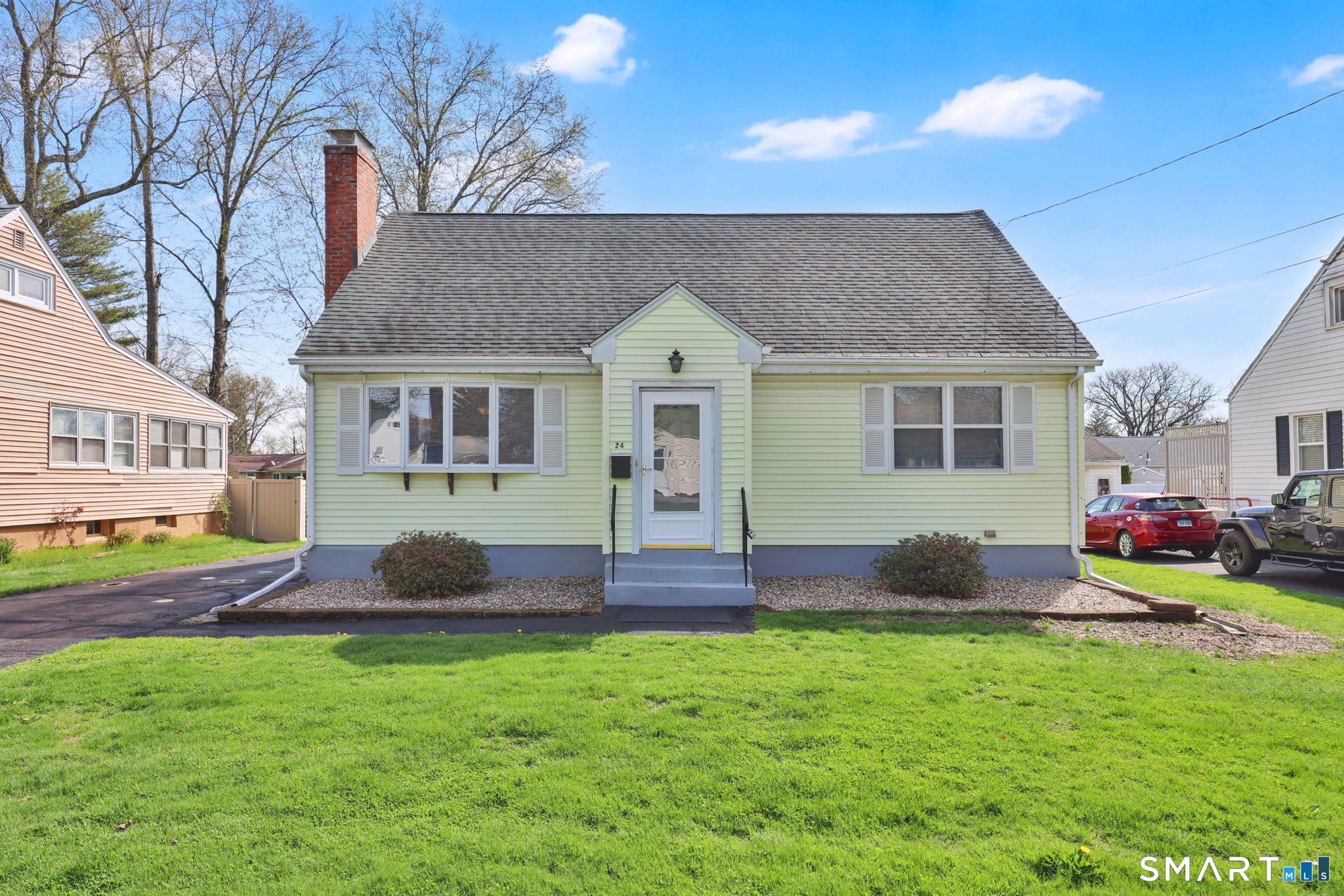a front view of house with yard and outdoor seating