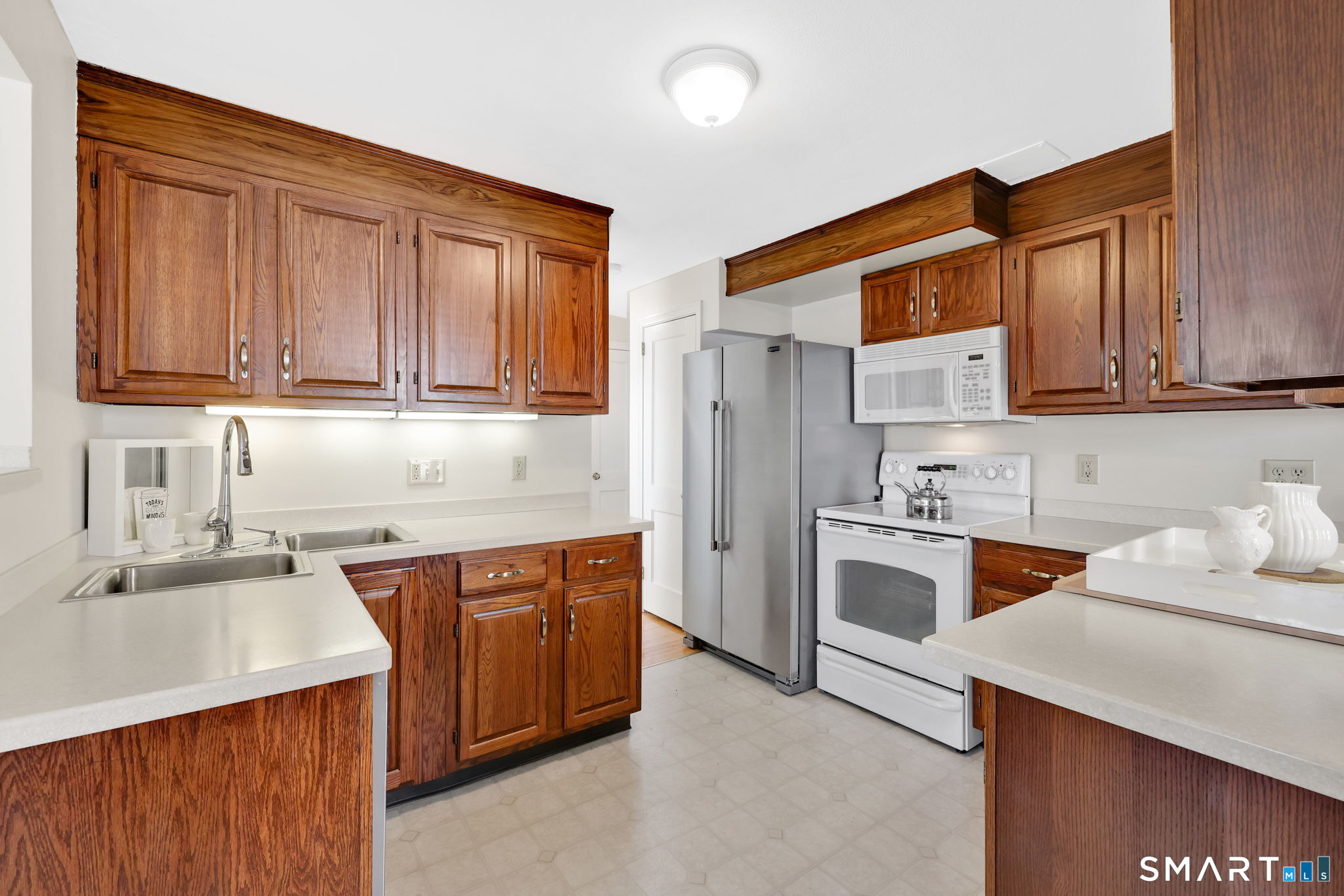 24 Madsen Road West Hartford, CT 06110 - Photo 14 of 38 a kitchen with stainless steel appliances granite countertop a sink stove refrigerator and cabinets