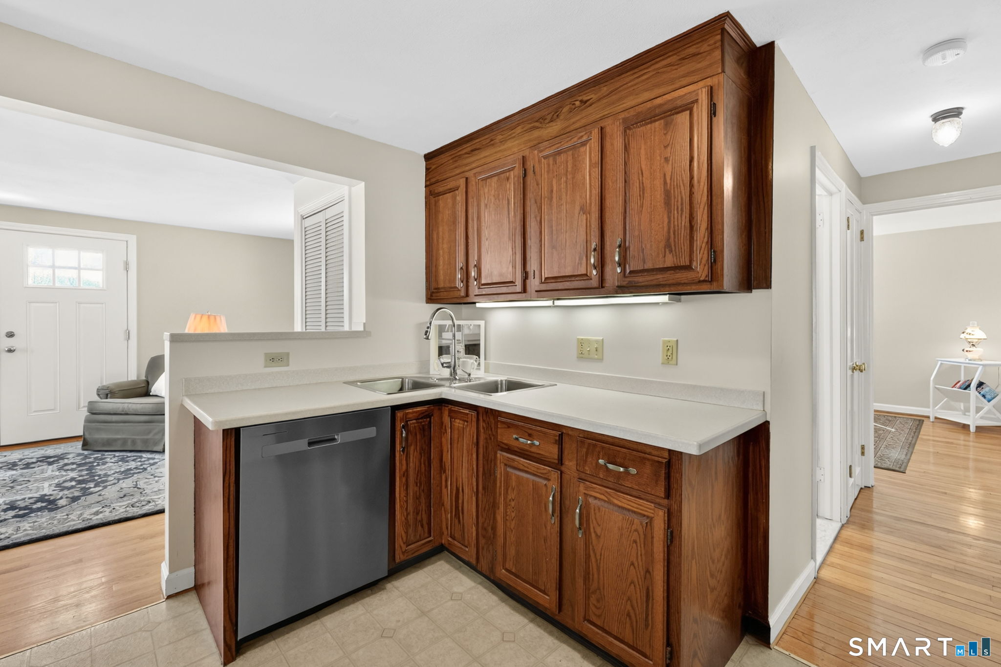 24 Madsen Road West Hartford, CT 06110 - Photo 16 of 38 a kitchen with a sink cabinets and wooden floor