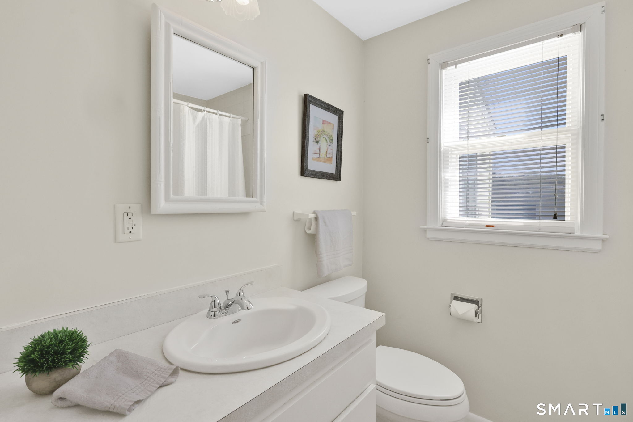 24 Madsen Road West Hartford, CT 06110 - Photo 19 of 38 a bathroom with a sink a toilet and a mirror