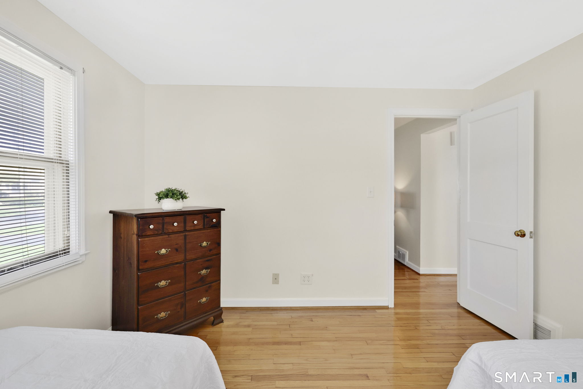 24 Madsen Road West Hartford, CT 06110 - Photo 22 of 38 a bedroom with a bed and wooden floor