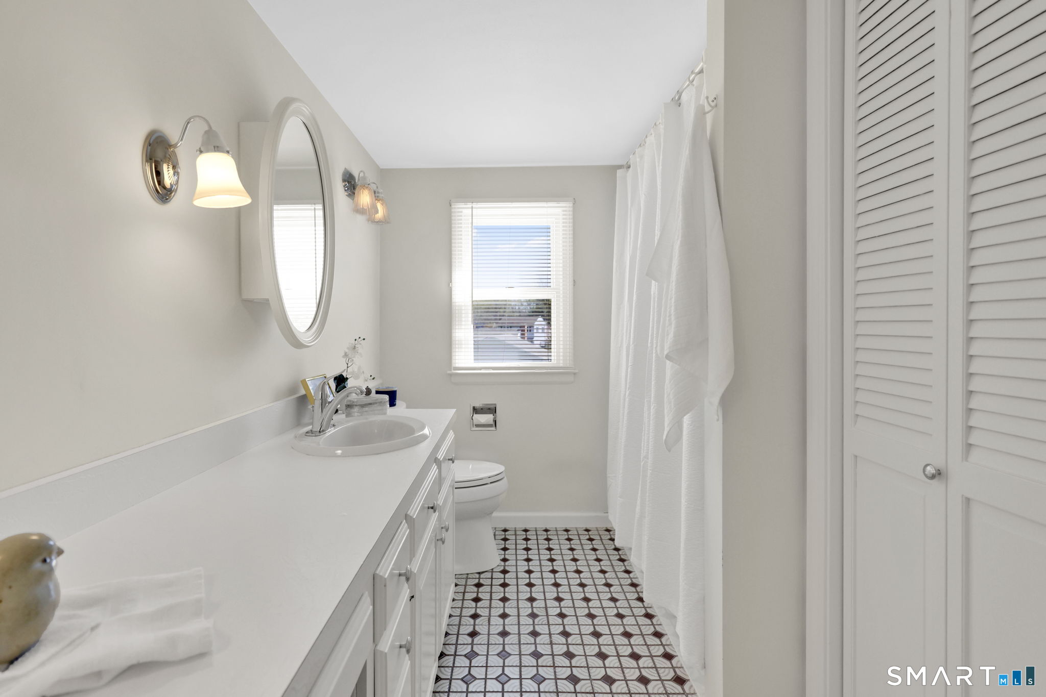 24 Madsen Road West Hartford, CT 06110 - Photo 23 of 38 a bathroom with a sink a toilet and a mirror