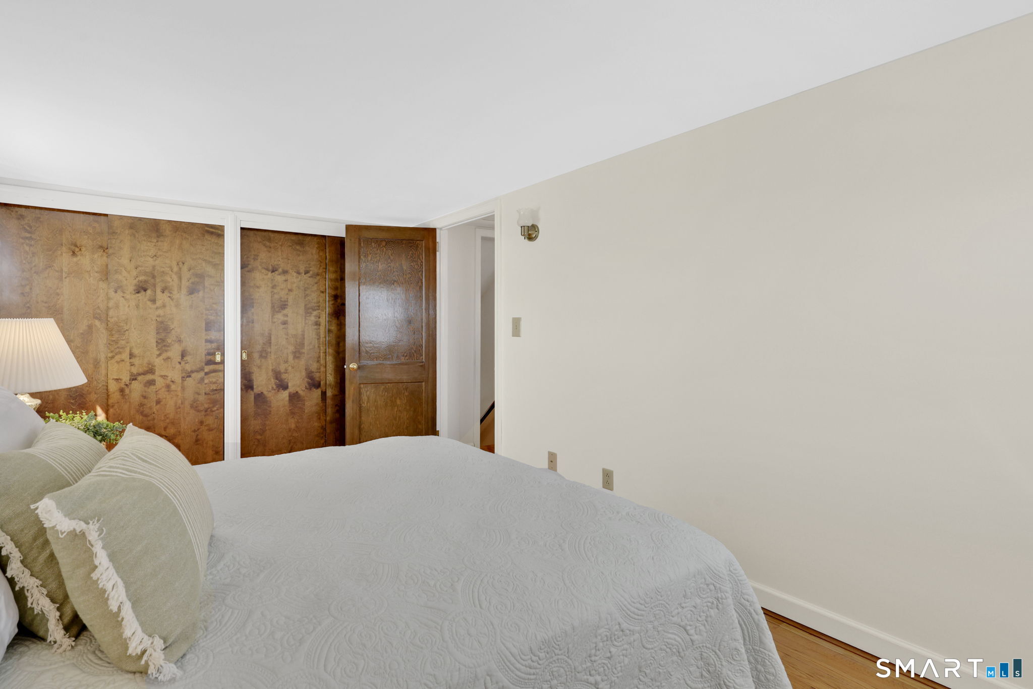 24 Madsen Road West Hartford, CT 06110 - Photo 25 of 38 a bedroom with a bed and a wall painting