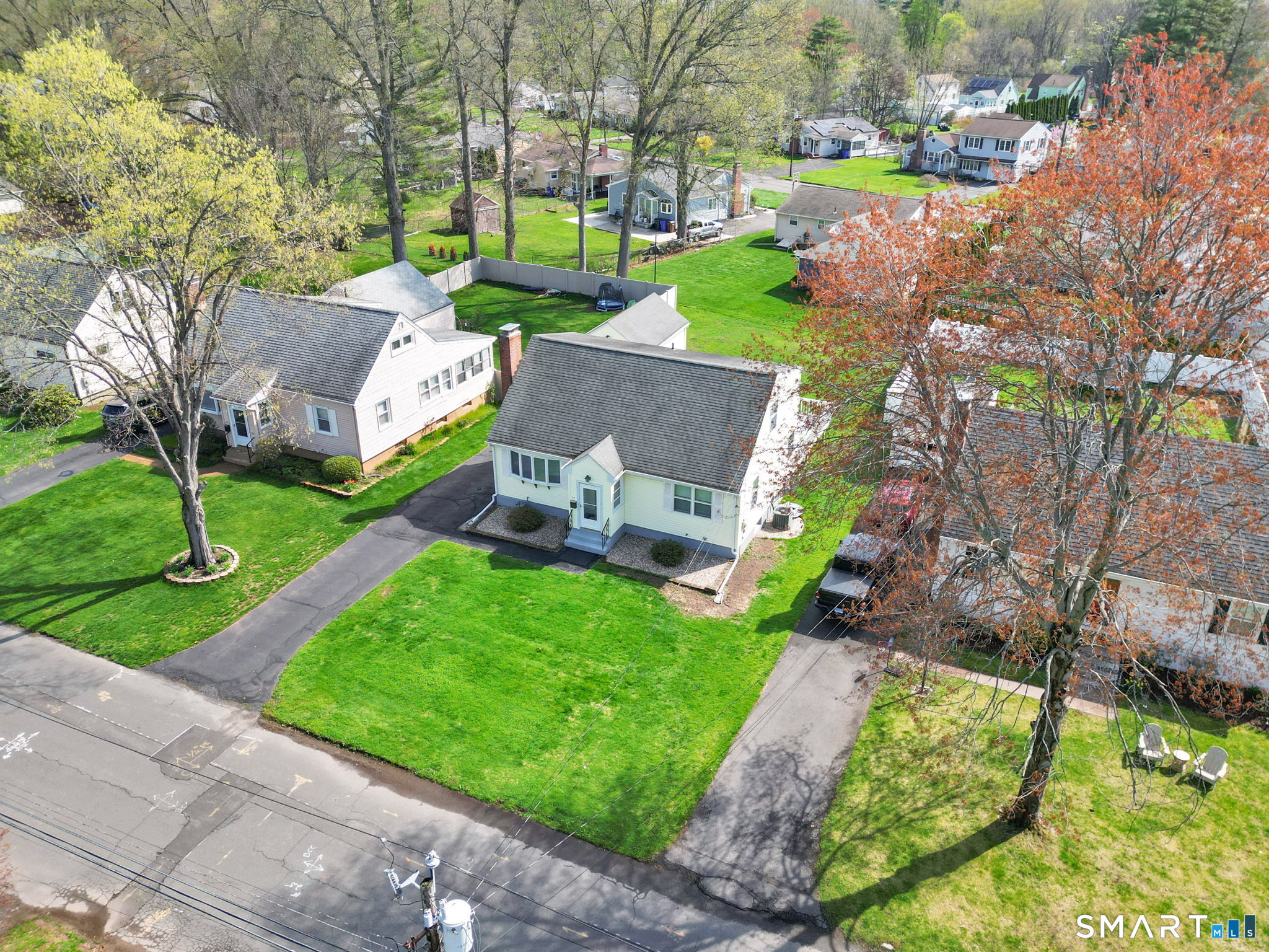 24 Madsen Road West Hartford, CT 06110 - Photo 36 of 38 front view of a house with a yard table and chairs
