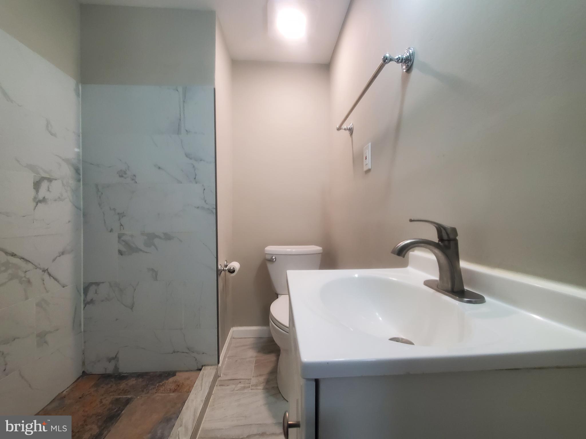 14813 Hammersmith Circle Silver Spring, MD 20906 - Photo 21 of 36 a bathroom with a sink a toilet and shower