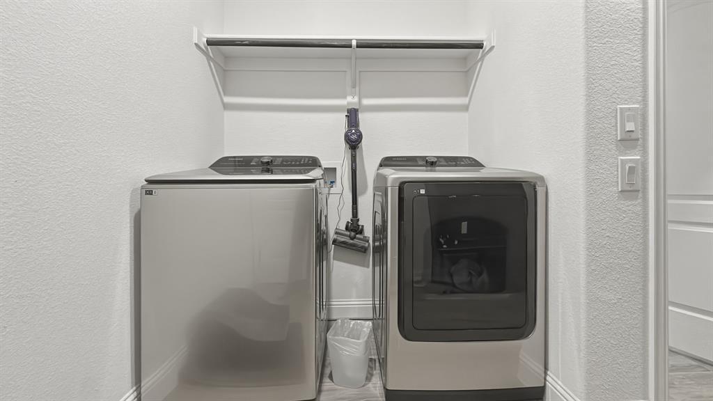 5216 Troupe Road McKinney, TX 75071 - Photo 39 of 40 Dedicated laundry area featuring a white shelf and hanging rod for storage, with textured white walls and light-colored baseboards