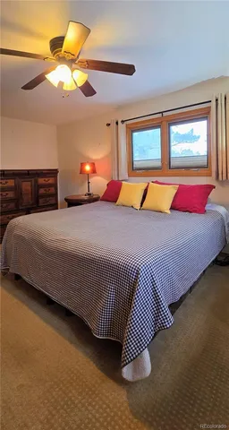 a bedroom with a bed and lamp