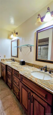 a bathroom with a granite countertop sink and a mirror