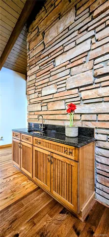 a utility room with stainless steel appliances a sink and cabinets