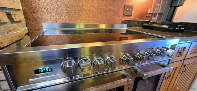 a stove top oven sitting inside of a kitchen