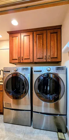 an aerial view of a house with yard and trees in the background