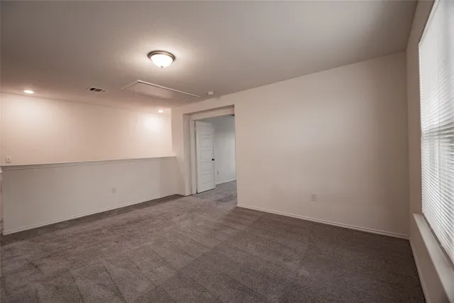 an empty room with a empty space and windows