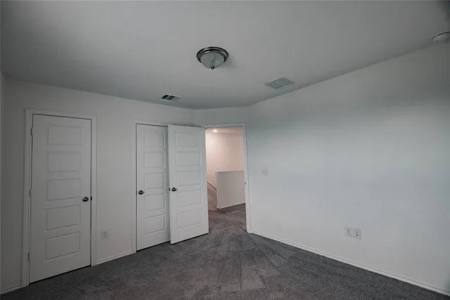 an empty room with a empty space and windows