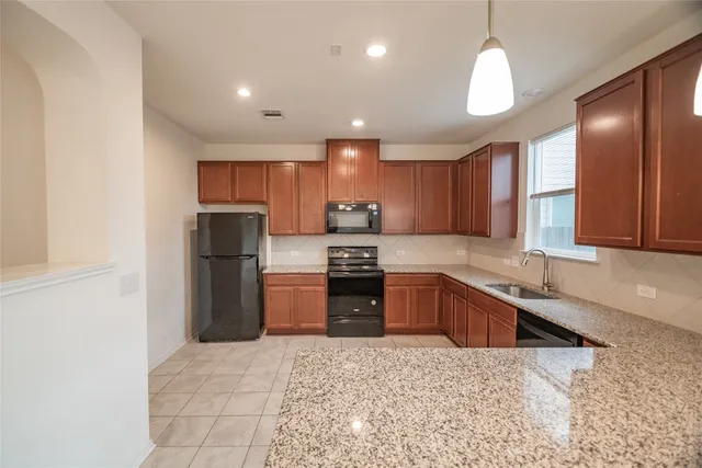 a view of a kitchen with a sink and a refrigerator