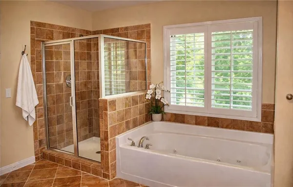 a bathroom with a bath tub and shower