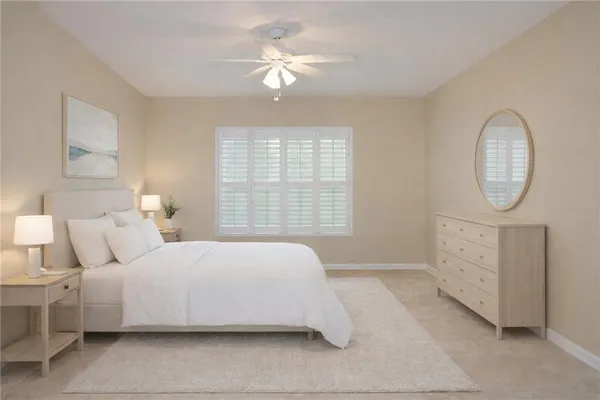 a bedroom with a bed a mirror and a window