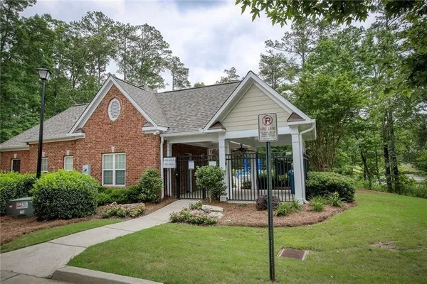 a front view of a house with a yard and potted plants
