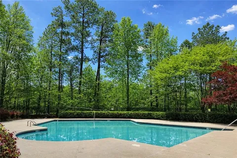 a view of a swimming pool with a yard