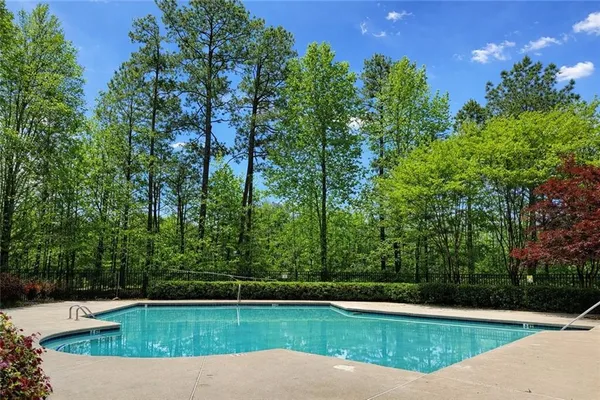 a view of a swimming pool with a yard
