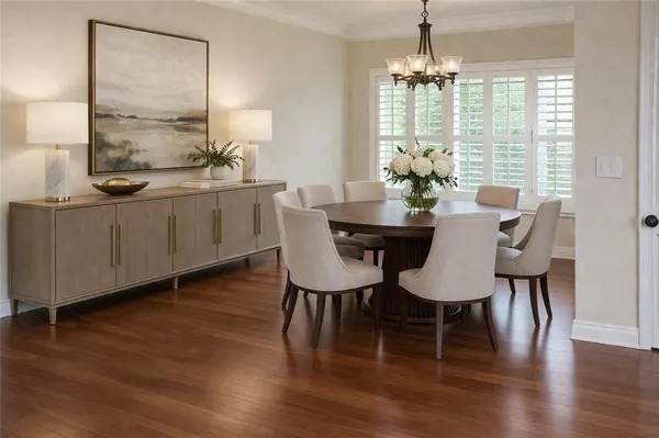 a dining room with furniture a chandelier and wooden floor