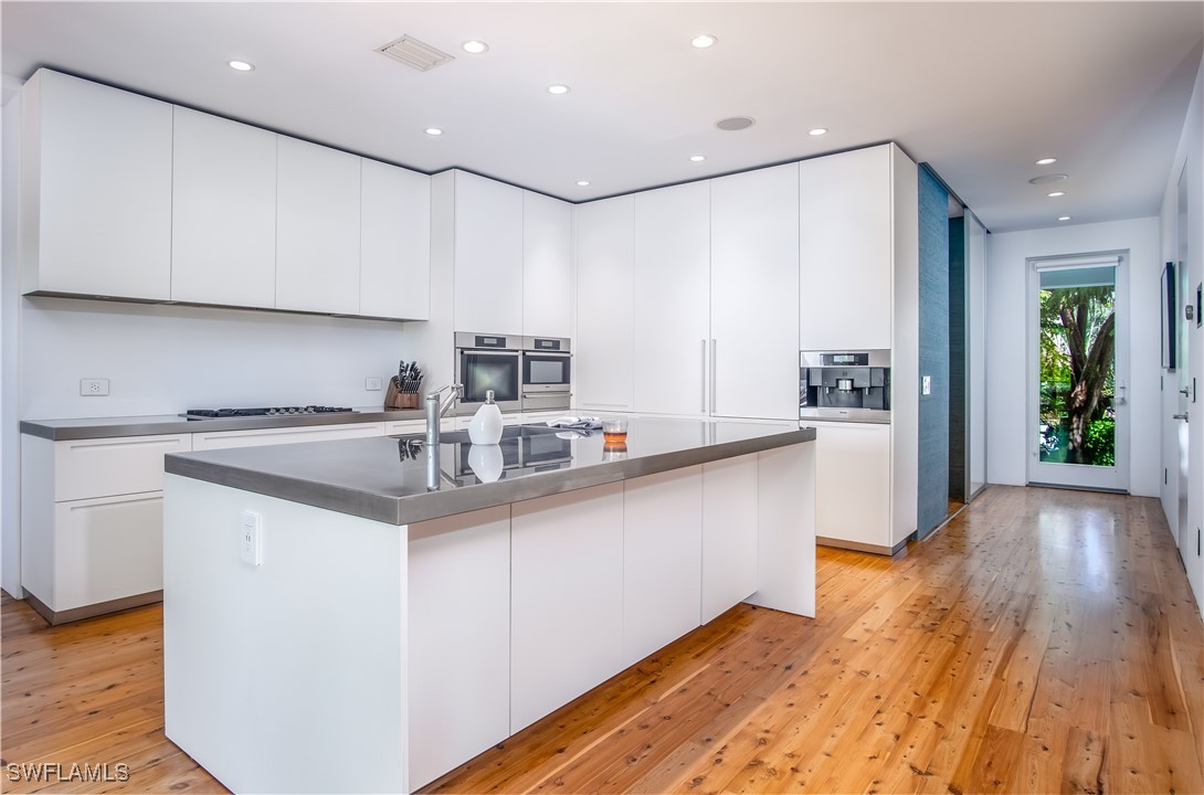 4 Coconut Drive Key West, FL 33040 - Photo 5 of 47 a kitchen with stainless steel appliances granite countertop a sink window and cabinets