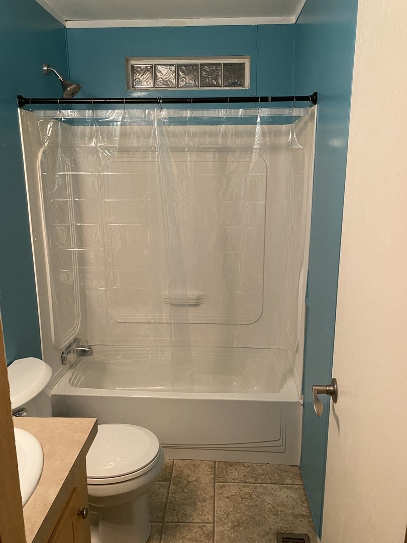 36 Cedar Street Minooka, IL 60447 - Photo 10 of 12 a bathroom with a shower a toilet and sink