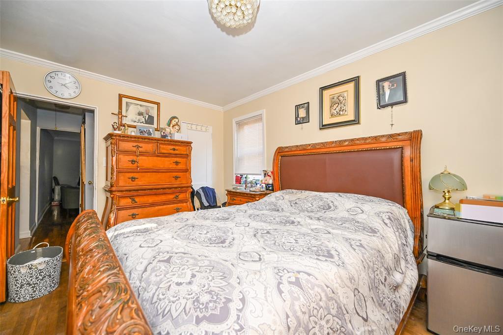 72-08 150th Street, Unit 199A Queens, NY 11367 - Photo 11 of 14 a bedroom with a bed and a dresser