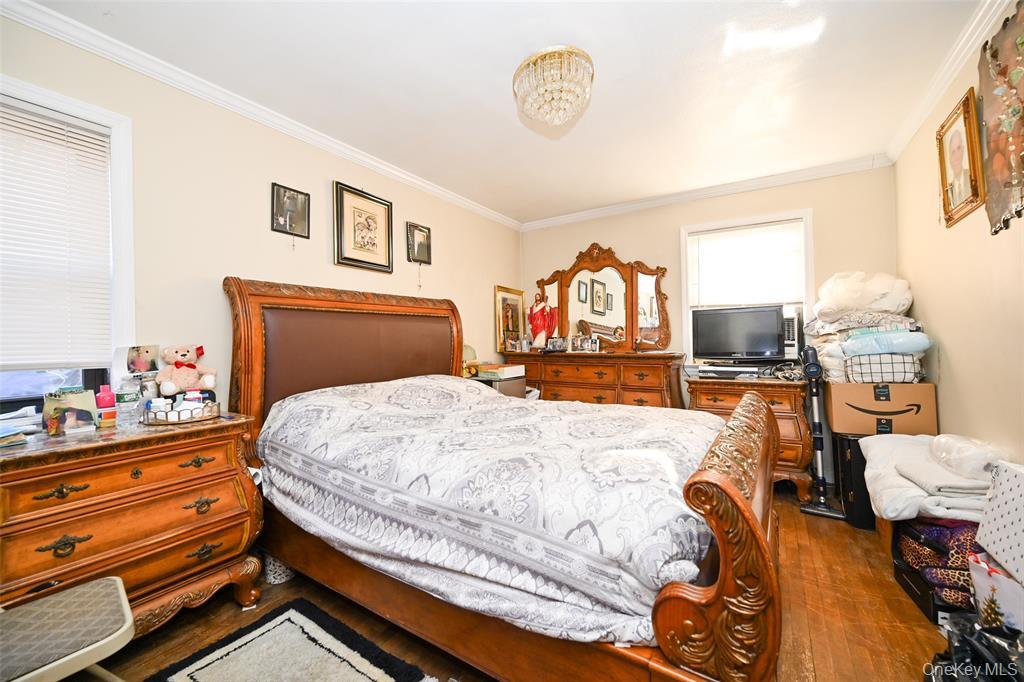 72-08 150th Street, Unit 199A Queens, NY 11367 - Photo 12 of 14 a bedroom with a bed and wooden floor