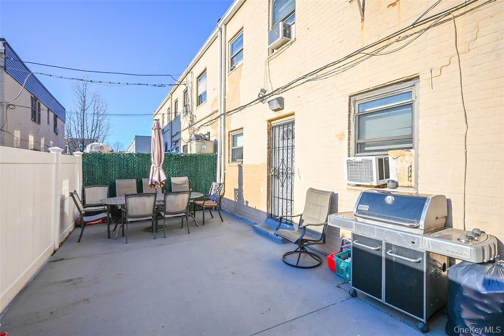 72-08 150th Street, Unit 199A Queens, NY 11367 - Photo 13 of 14 a backyard of a house with fire pit and chairs