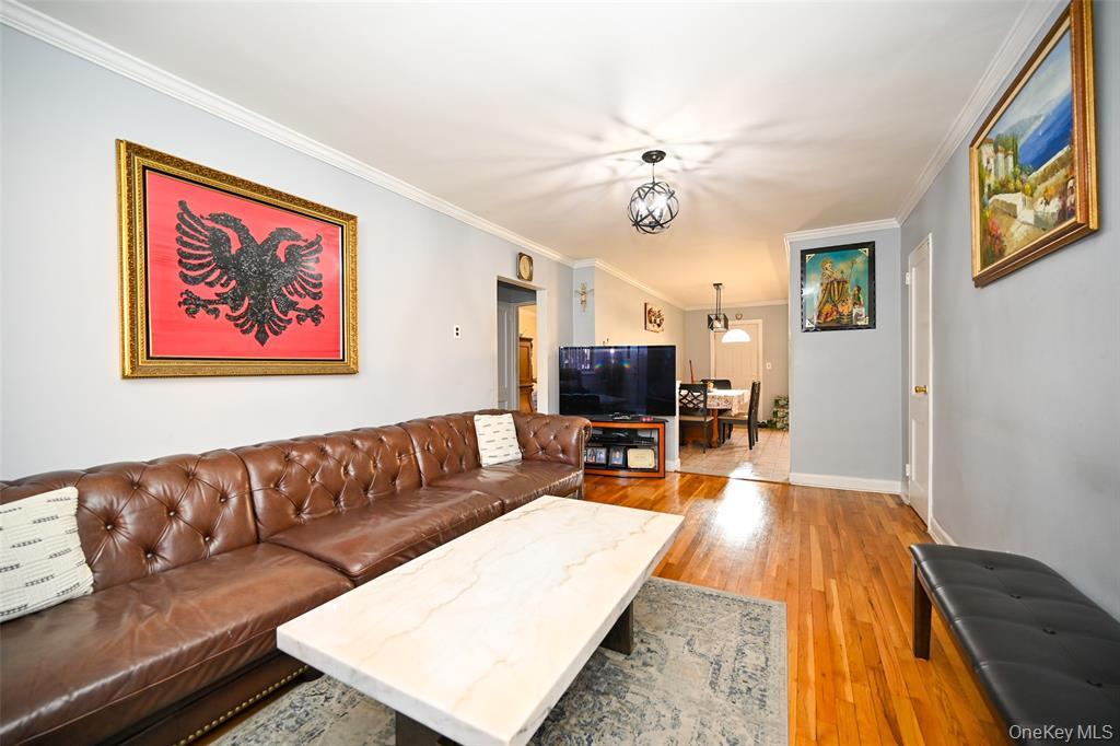 72-08 150th Street, Unit 199A Queens, NY 11367 - Photo 4 of 14 a living room with furniture and a flat screen tv
