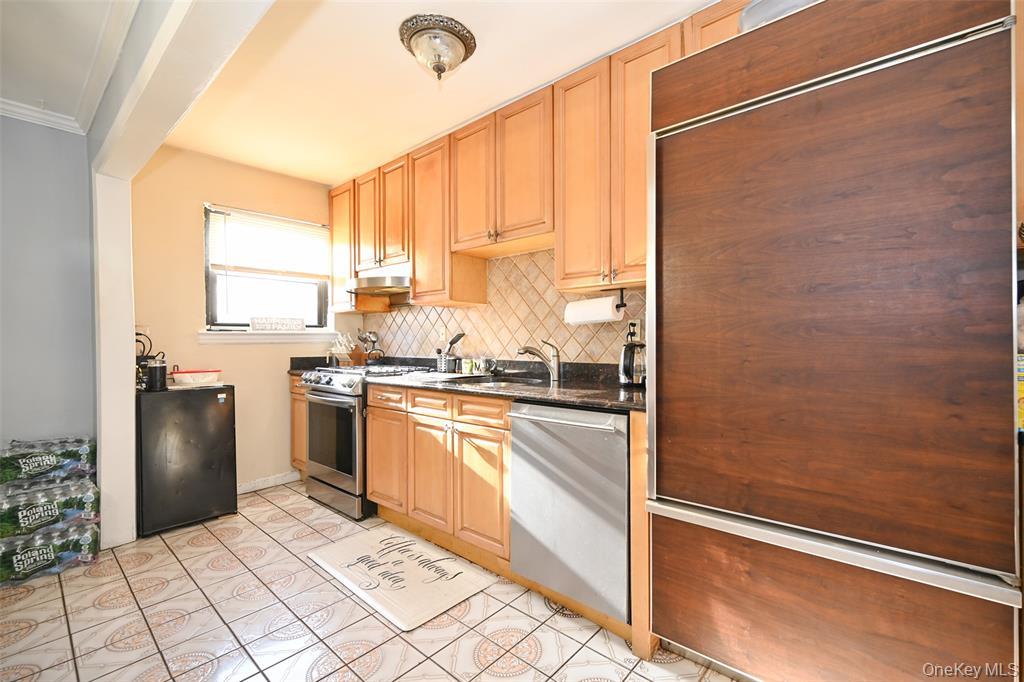 72-08 150th Street, Unit 199A Queens, NY 11367 - Photo 6 of 14 a kitchen with stainless steel appliances granite countertop a refrigerator and a sink