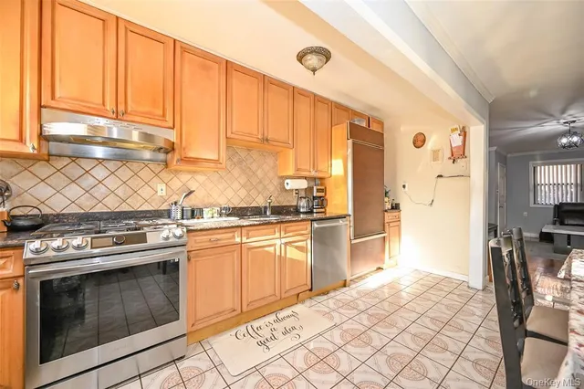 a kitchen with a stove a sink and a refrigerator