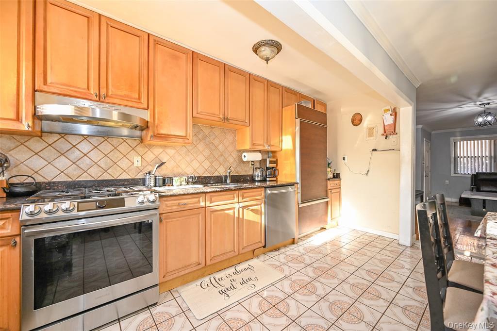 72-08 150th Street, Unit 199A Queens, NY 11367 - Photo 7 of 14 a kitchen with a stove a sink and a refrigerator