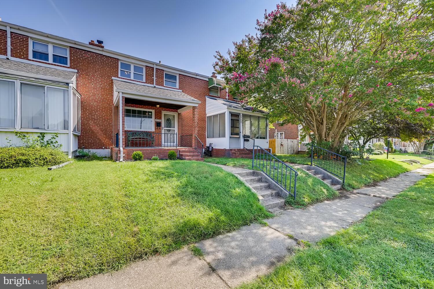 2720 Moorgate Road Baltimore, MD 21222 - Photo 2 of 28 a front view of a house with a yard and potted plants