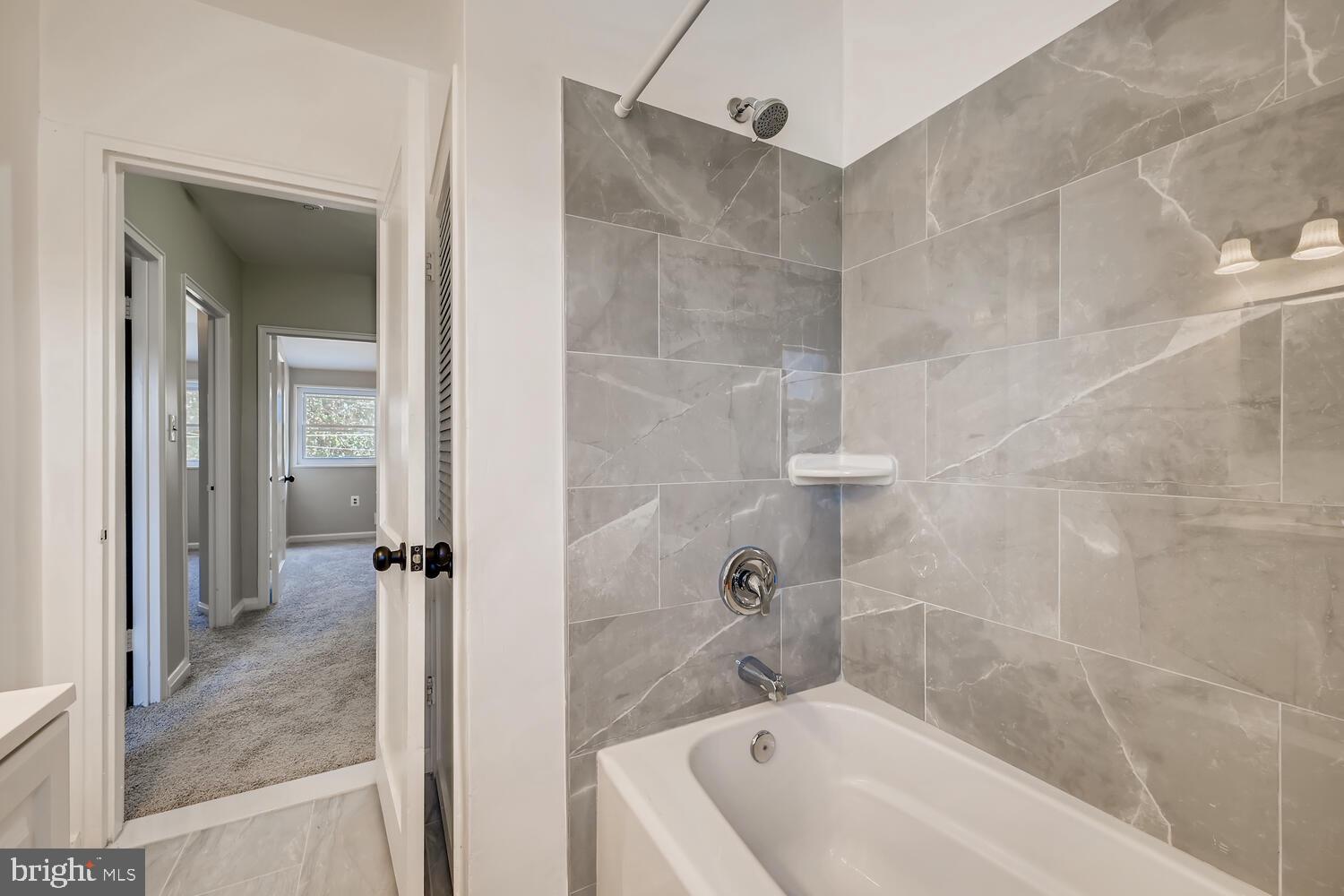 2720 Moorgate Road Baltimore, MD 21222 - Photo 16 of 28 a bathroom with a tub shower vanity and a sink