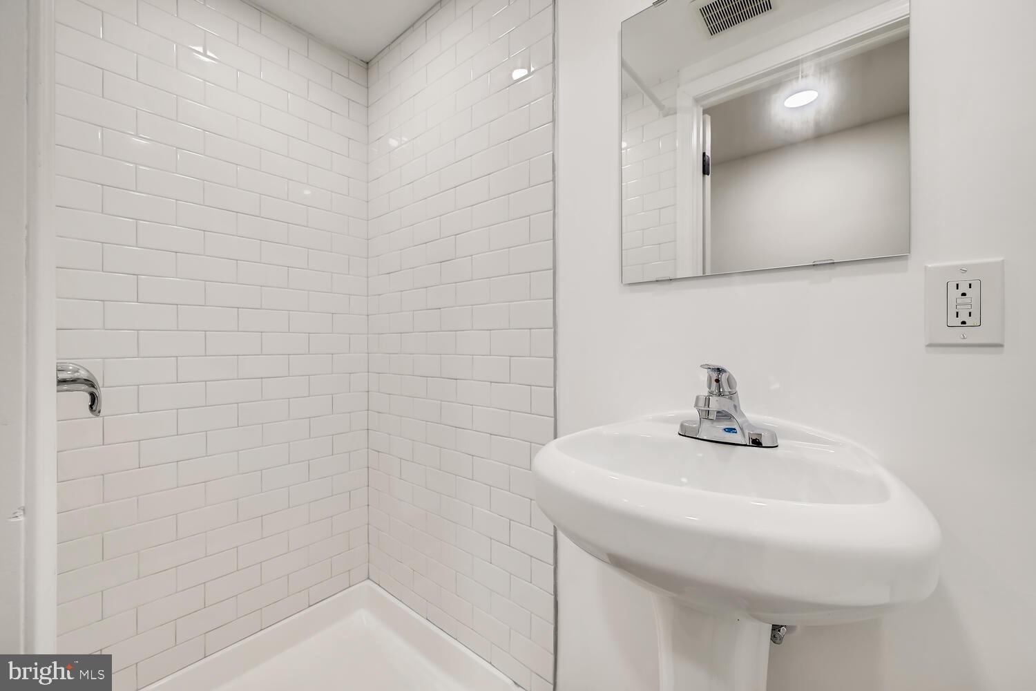 2720 Moorgate Road Baltimore, MD 21222 - Photo 22 of 28 a bathroom with a sink a vanity and mirror